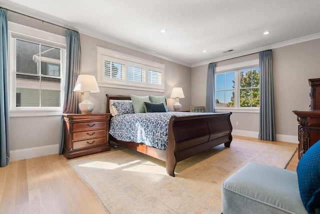 bedroom with baseboards, wood finished floors, and crown molding