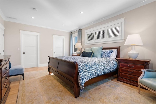 bedroom featuring light wood finished floors, ornamental molding, and recessed lighting