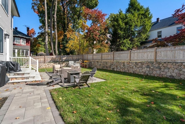 view of yard featuring an outdoor fire pit, a patio area, and a fenced backyard