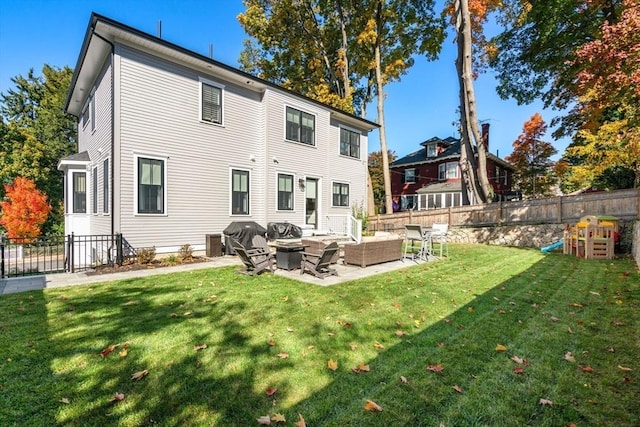 back of property with a yard, fence, an outdoor hangout area, and a patio