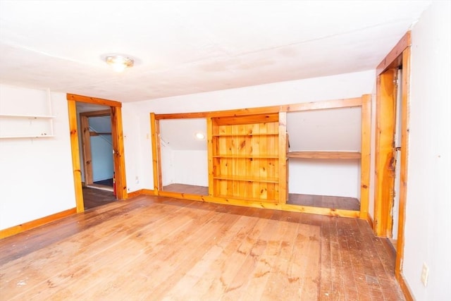 empty room with baseboards and hardwood / wood-style floors