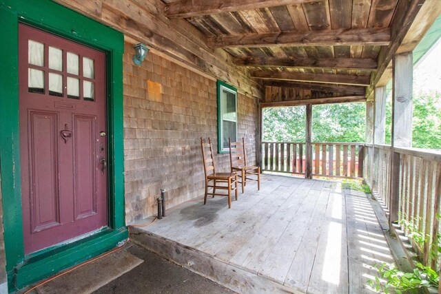 ranch-style house with a porch and a front yard