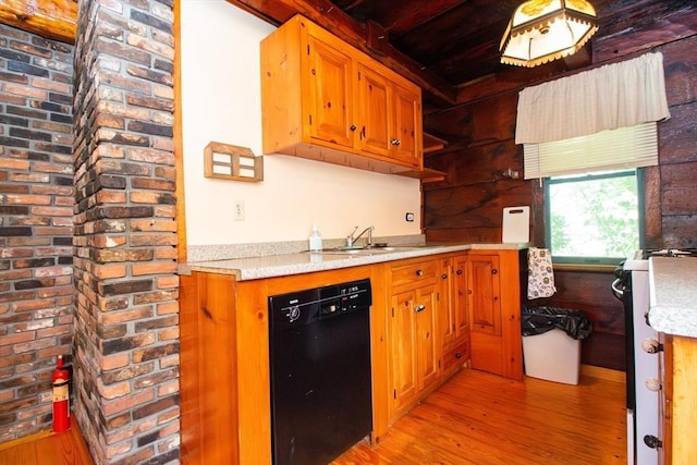 kitchen with light countertops, dishwasher, light wood-style flooring, and a sink