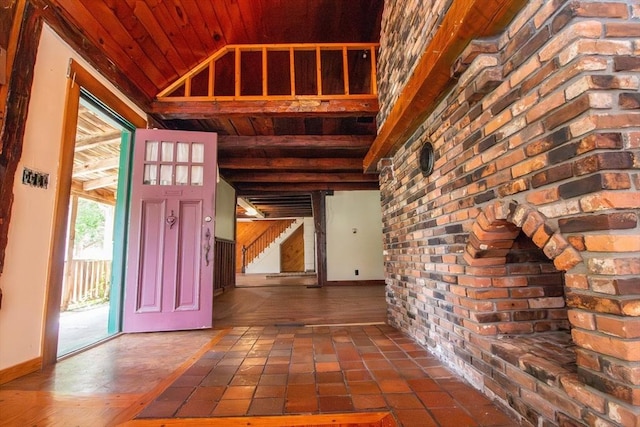 foyer entrance featuring lofted ceiling, wooden ceiling, and baseboards