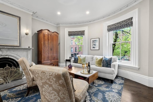 sitting room featuring crown molding, recessed lighting, wood finished floors, baseboards, and a fireplace