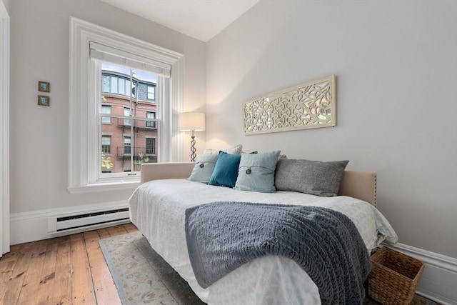 bedroom featuring a baseboard radiator and wood-type flooring