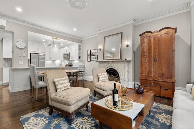 living area featuring crown molding, recessed lighting, wood finished floors, a fireplace, and baseboards