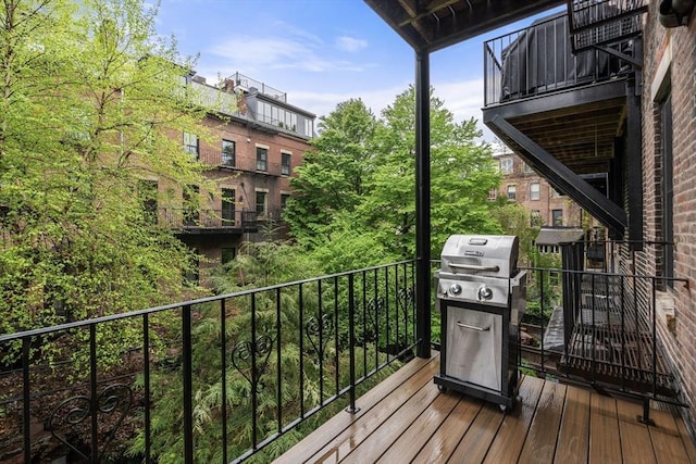wooden terrace featuring a grill