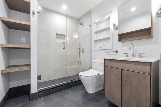 bathroom featuring a shower with door, vanity, built in shelves, tile patterned floors, and toilet