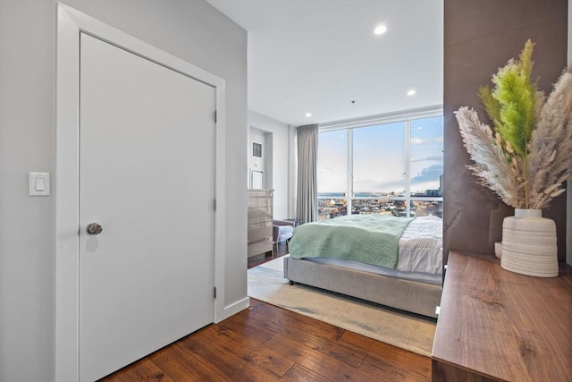 bedroom featuring hardwood / wood-style flooring and expansive windows