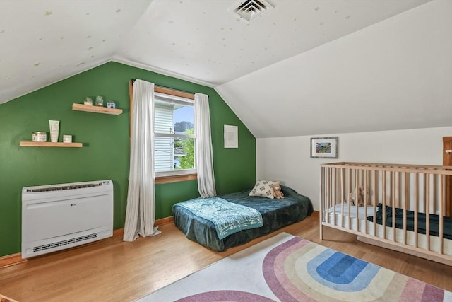 109 Euclid Ave, Pittsfield, MA 01201 - bedroom featuring heating unit, wood finished floors, and vaulted ceiling