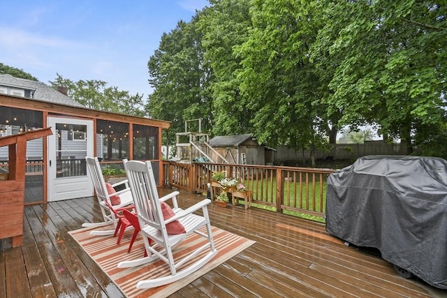 109 Euclid Ave, Pittsfield, MA 01201 - wooden deck featuring a sunroom, a storage unit, a fenced backyard, and a grill
