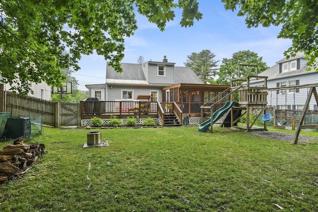 109 Euclid Ave, Pittsfield, MA 01201 - rear view of house with a sunroom, a playground, a fenced backyard, a chimney, and a deck