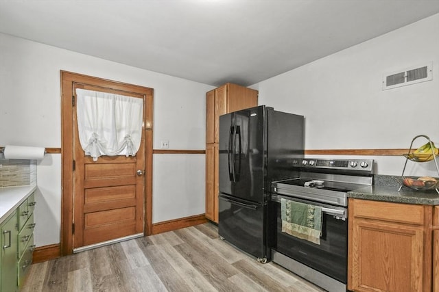 109 Euclid Ave, Pittsfield, MA 01201 - kitchen with electric range, light wood-style floors, freestanding refrigerator, and brown cabinetry