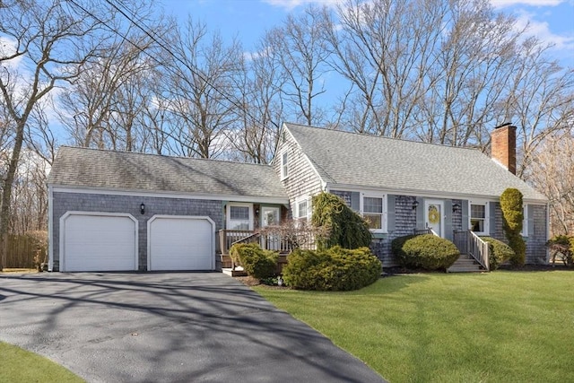 view of front of house featuring aphalt driveway, a front yard, a shingled roof, a garage, and a chimney