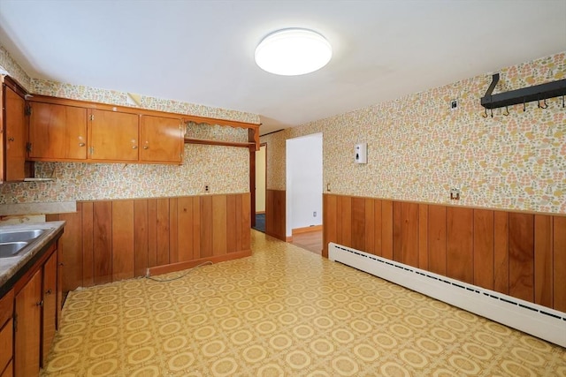 kitchen with wood walls and a baseboard radiator