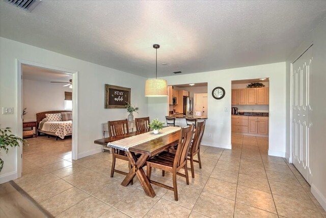 1656 Saint Clair Ave E, Fort Myers, FL 33903 - tiled dining room with ceiling fan and a textured ceiling