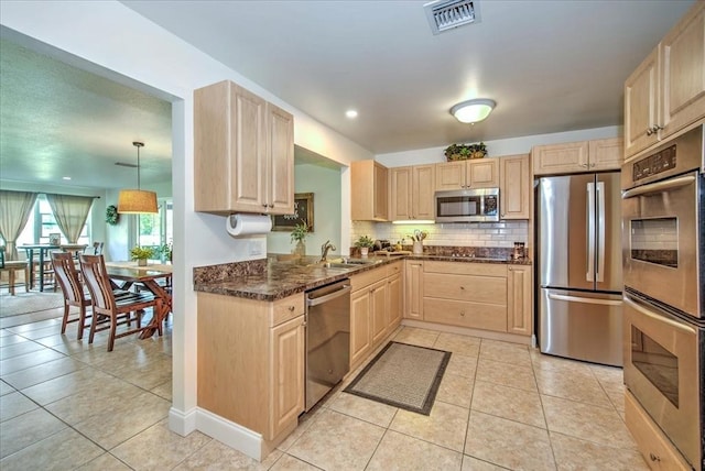 1656 Saint Clair Ave E, Fort Myers, FL 33903 - kitchen featuring light brown cabinetry, sink, decorative light fixtures, and stainless steel appliances