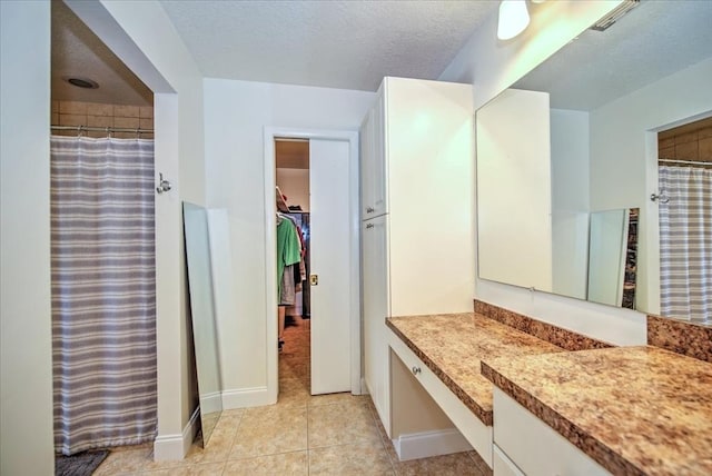 1656 Saint Clair Ave E, Fort Myers, FL 33903 - bathroom featuring tile patterned floors, vanity, curtained shower, and a textured ceiling
