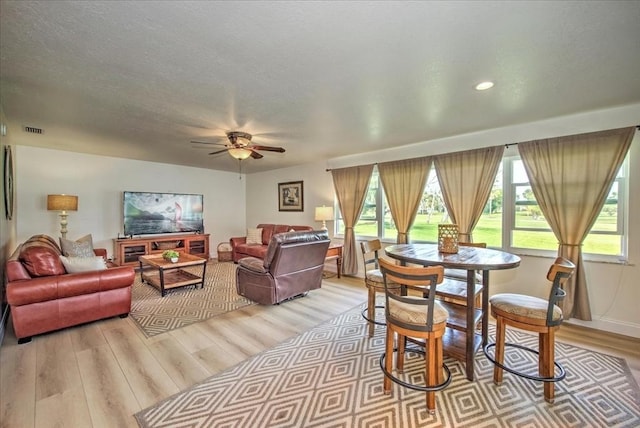 1656 Saint Clair Ave E, Fort Myers, FL 33903 - dining space with a textured ceiling, ceiling fan, and light wood-type flooring