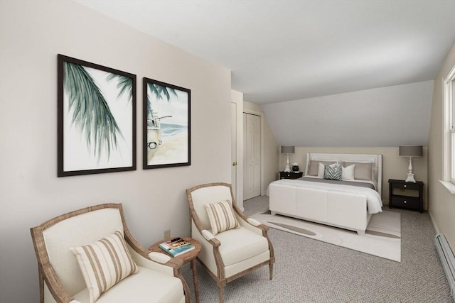 bedroom featuring vaulted ceiling, baseboard heating, and carpet