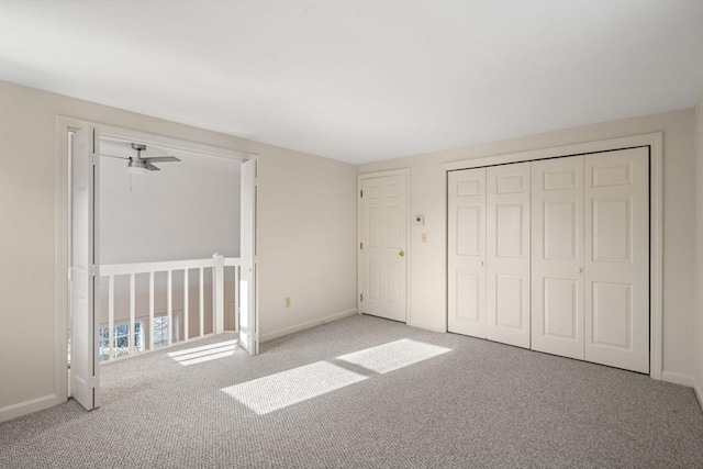 unfurnished bedroom featuring a closet and light carpet