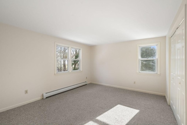 empty room with a baseboard radiator and light colored carpet