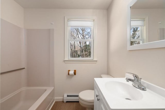 bathroom with vanity, hardwood / wood-style floors, toilet, and baseboard heating