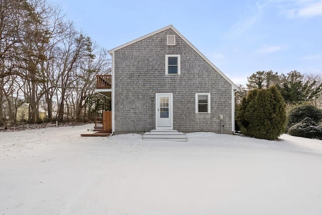 view of snow covered rear of property