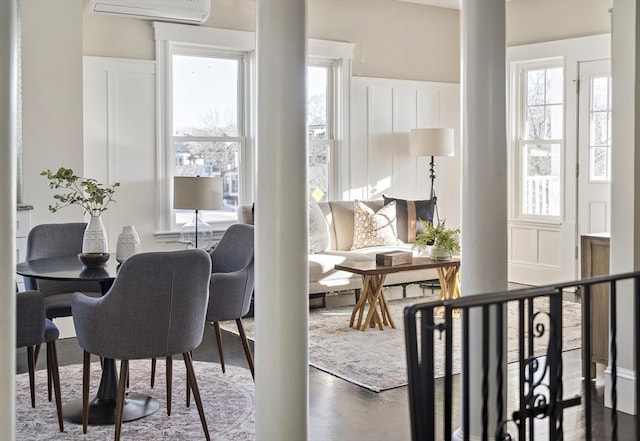 dining area with an AC wall unit and dark hardwood / wood-style floors