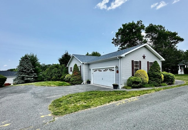 1408 Fox Run, Middleboro, MA 02346 - view of side of property featuring a garage and asphalt driveway