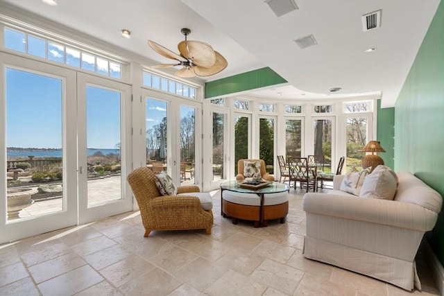 sunroom featuring visible vents, stone tile floors, recessed lighting, and french doors