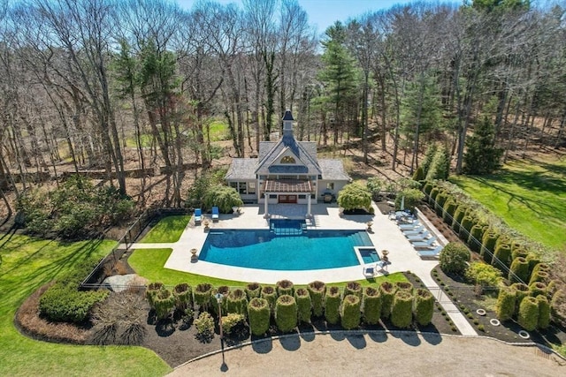 outdoor pool with an exterior structure, fence, a diving board, an outdoor structure, and a patio