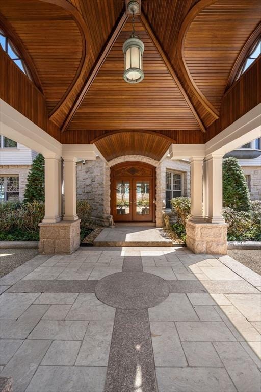 doorway to property featuring french doors and stone siding