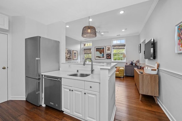 60 Glen Rd Unit 201, Brookline, MA 02445 - kitchen featuring a sink, appliances with stainless steel finishes, dark wood finished floors, white cabinets, and crown molding