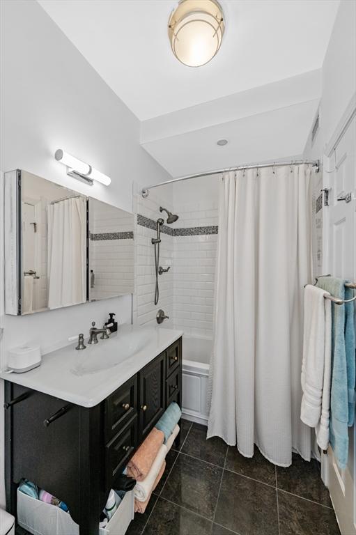 60 Glen Rd Unit 201, Brookline, MA 02445 - bathroom featuring vanity, tile patterned floors, and shower / bath combo with shower curtain
