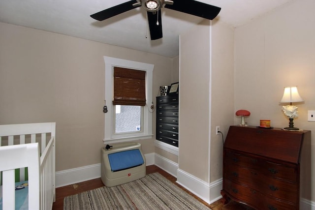 bedroom with wood finished floors and baseboards