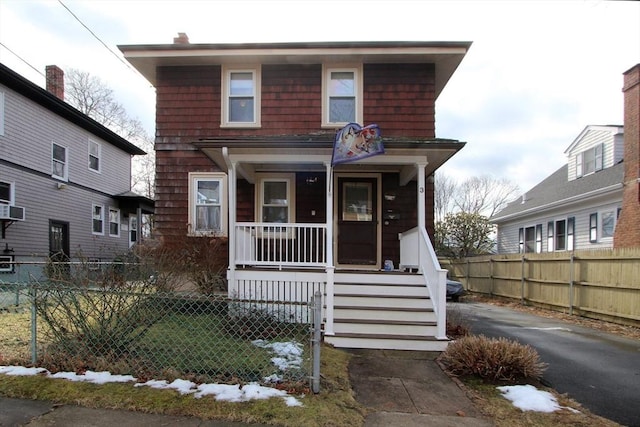 view of front of home featuring a fenced front yard and a porch