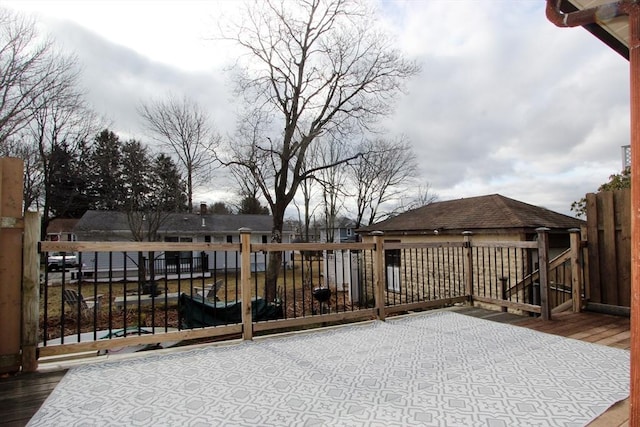 wooden terrace featuring fence