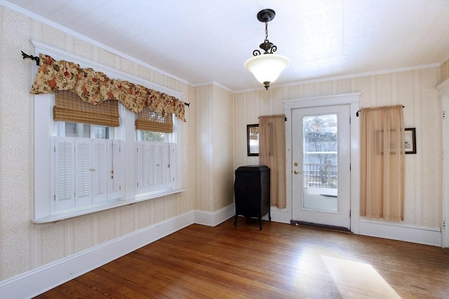 entryway featuring wallpapered walls, crown molding, and hardwood / wood-style floors