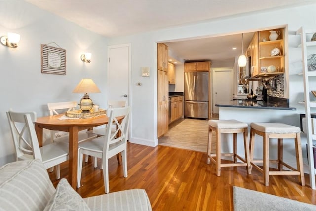 dining area featuring light wood-style floors