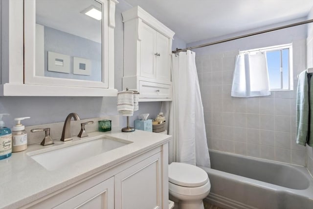 full bathroom featuring toilet, shower / bath combo, and vanity