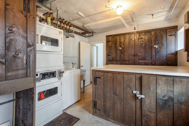kitchen featuring stacked washer / drying machine and light countertops