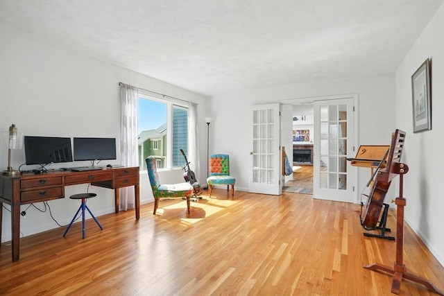 office with french doors, baseboards, and wood finished floors