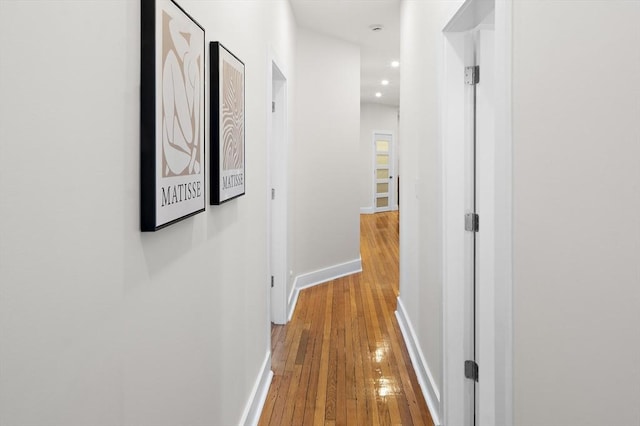hall with wood-type flooring, recessed lighting, and baseboards