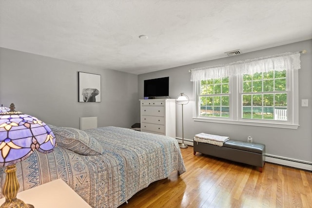 10 Lisa Ln, Reading, MA 01867 - bedroom featuring baseboard heating and wood finished floors