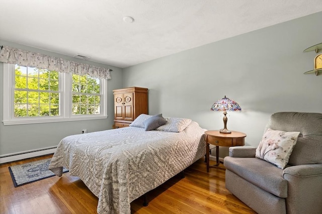10 Lisa Ln, Reading, MA 01867 - bedroom with wood finished floors and a baseboard radiator