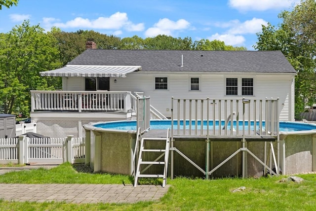 10 Lisa Ln, Reading, MA 01867 - back of property with a wooden deck, an outdoor pool, and a chimney