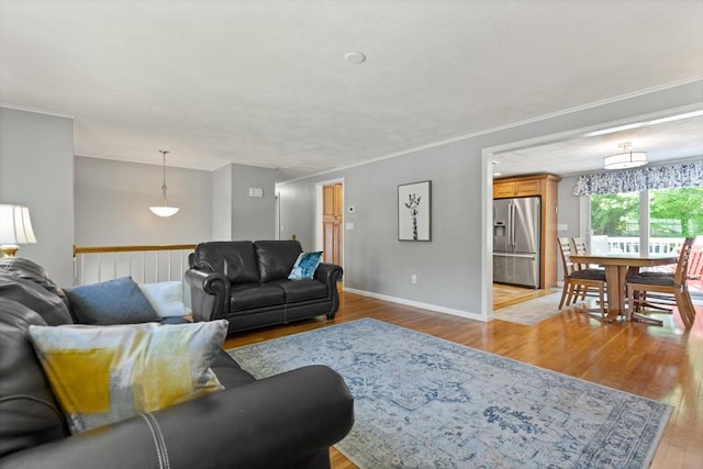 10 Lisa Ln, Reading, MA 01867 - living area with attic access, wood finished floors, baseboards, and crown molding