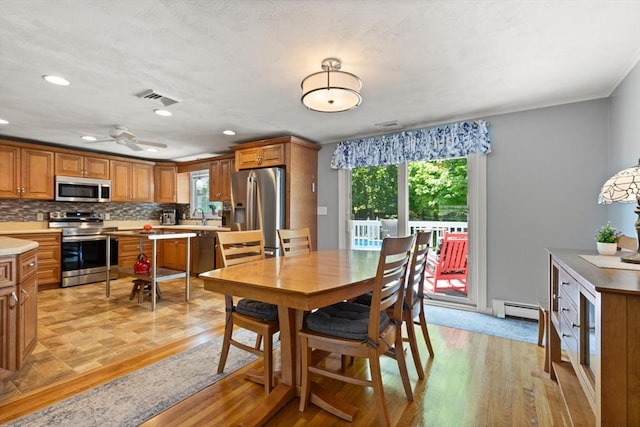 10 Lisa Ln, Reading, MA 01867 - dining space featuring baseboard heating, light wood-type flooring, a ceiling fan, recessed lighting, and crown molding